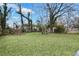 Large backyard with grass and mature trees providing ample space and privacy at 2243 Newnan St, Atlanta, GA 30344