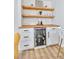 Close up of the bar area with floating wood shelves, wine cooler and white cabinets at 2243 Newnan St, Atlanta, GA 30344