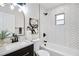 Modern bathroom with herringbone tile, black fixtures, and arched mirror at 2243 Newnan St, Atlanta, GA 30344