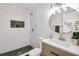 Updated bathroom features subway tile shower, modern vanity, and round mirror at 2243 Newnan St, Atlanta, GA 30344