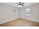 Bedroom with two windows, ceiling fan, and neutral colors at 2243 Newnan St, Atlanta, GA 30344