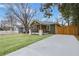 Well-maintained home with fresh green lawn, new driveway, and charming front porch at 2243 Newnan St, Atlanta, GA 30344