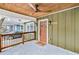 Charming covered front porch with stained ceiling and modern ceiling fan at 2243 Newnan St, Atlanta, GA 30344