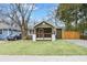Charming bungalow featuring a well-manicured lawn and a welcoming front porch with wooden beams and railings at 2243 Newnan St, Atlanta, GA 30344