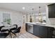 View of the kitchen featuring gray cabinets, modern lighting, and stainless steel appliances at 2243 Newnan St, Atlanta, GA 30344