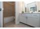 Tiled bathroom with a shower-tub combination and a vanity with ample storage space at 532 Pearl St, Cumming, GA 30040