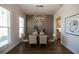 Formal dining room with chandelier, wainscoting, wood floors, and large windows allowing plenty of natural light at 532 Pearl St, Cumming, GA 30040