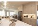 Open concept kitchen with stainless appliances, quartz countertops and breakfast bar with views to living room at 532 Pearl St, Cumming, GA 30040