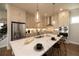 Modern kitchen with stainless steel appliances, stone countertops and an island with bar stool seating at 532 Pearl St, Cumming, GA 30040