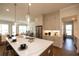 Bright kitchen boasts a large marble island, stainless steel appliances, and modern pendant lighting at 532 Pearl St, Cumming, GA 30040