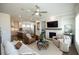 Open concept living room with stone fireplace, ceiling fan, and view to kitchen at 532 Pearl St, Cumming, GA 30040