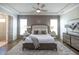 Relaxing main bedroom featuring a tray ceiling, soft lighting, and neutral colors creating a tranquil retreat at 532 Pearl St, Cumming, GA 30040