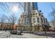 Modern building exterior showcasing architectural details, ground-level businesses, and a vibrant city street at 860 Peachtree Ne St # 2212, Atlanta, GA 30308