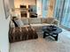 Comfortable living area with plush sofa, soft rug, adjacent to a modern, well-lit kitchen at 860 Peachtree Ne St # 2212, Atlanta, GA 30308
