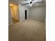 Spacious carpeted bedroom with neutral walls, ceiling fan, and a doorway leading to another room at 10918 Gallier St, Alpharetta, GA 30022