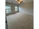 Spacious bedroom featuring neutral tones, plush carpeting, and large windows for ample natural light at 10918 Gallier St, Alpharetta, GA 30022