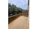 A wooden deck with a railing overlooks a private wooded area, perfect for outdoor relaxation at 10918 Gallier St, Alpharetta, GA 30022
