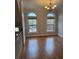Bright dining area with hardwood floors, arched windows, and decorative chandelier at 10918 Gallier St, Alpharetta, GA 30022