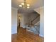 Beautiful foyer with hardwood floors, staircase, chandelier and half bath nearby at 10918 Gallier St, Alpharetta, GA 30022