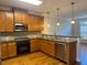Modern kitchen featuring stainless steel appliances, granite countertops, and wooden cabinetry at 10918 Gallier St, Alpharetta, GA 30022