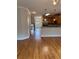 Open-concept living area with hardwood floors, view of kitchen, and lots of natural light at 10918 Gallier St, Alpharetta, GA 30022