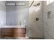 Modern bathroom features double sinks in a wood vanity and an elegant tile shower stall at 1831 Jonesboro Se Rd, Atlanta, GA 30315