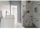 Bathroom featuring a vanity and shower with large marble-patterned tile at 1831 Jonesboro Se Rd, Atlanta, GA 30315
