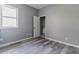 Bedroom with gray walls and vinyl plank flooring, with view into bathroom at 1831 Jonesboro Se Rd, Atlanta, GA 30315