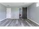 Bedroom features light gray walls, plank floors, and a sliding barn door leading to the bathroom at 1831 Jonesboro Se Rd, Atlanta, GA 30315