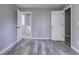 Bedroom featuring gray walls, vinyl plank flooring, with view into bathroom at 1831 Jonesboro Se Rd, Atlanta, GA 30315