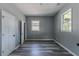 Bedroom featuring gray walls, vinyl plank flooring, and natural light from two windows at 1831 Jonesboro Se Rd, Atlanta, GA 30315