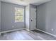 Bedroom with grey walls, vinyl plank flooring, and natural light at 1831 Jonesboro Se Rd, Atlanta, GA 30315