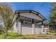 Charming white home with black trim, a lovely covered porch, and mature trees at 1831 Jonesboro Se Rd, Atlanta, GA 30315