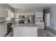 Well-lit kitchen featuring white cabinets, granite countertops, and stainless steel appliances at 1831 Jonesboro Se Rd, Atlanta, GA 30315