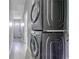 Laundry room features gray, stacked washer and dryer units conveniently located next to a hallway at 1831 Jonesboro Se Rd, Atlanta, GA 30315