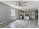 Open living space with modern gray walls, wood flooring, and a fan at 1831 Jonesboro Se Rd, Atlanta, GA 30315