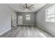 Spacious living room with a ceiling fan, wood flooring, and neutral gray paint at 1831 Jonesboro Se Rd, Atlanta, GA 30315