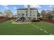 Expansive backyard featuring a spacious lawn, charming stone fire pit, and elevated deck at 5280 Oak Hill Ter, Cumming, GA 30040