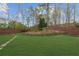 Well-maintained backyard with a lush lawn, retaining wall and privacy fence at 5280 Oak Hill Ter, Cumming, GA 30040