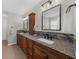 Bathroom features a double vanity with granite counters, mosaic backsplash, and dark wood cabinets at 5280 Oak Hill Ter, Cumming, GA 30040