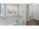 Bathroom with a large soaking tub, separate shower, and tile flooring at 5280 Oak Hill Ter, Cumming, GA 30040