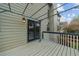 Spacious deck area with views of the backyard, complete with string lights at 5280 Oak Hill Ter, Cumming, GA 30040