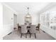 Bright dining room with crown molding, chandelier, and large windows at 5280 Oak Hill Ter, Cumming, GA 30040