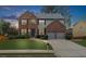 Charming two-story brick home featuring a well-manicured lawn and a two-car garage at 5280 Oak Hill Ter, Cumming, GA 30040