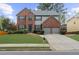 Beautiful two-story brick home with a well-manicured lawn and a two-car garage at 5280 Oak Hill Ter, Cumming, GA 30040