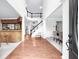 Bright foyer with wood floors, leading to a staircase and open-concept living spaces at 5280 Oak Hill Ter, Cumming, GA 30040