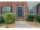 Close-up of the home's front door, showcasing a decorative glass insert and sidelights at 5280 Oak Hill Ter, Cumming, GA 30040