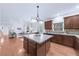 Kitchen area with hardwood floors and open view to the living room at 5280 Oak Hill Ter, Cumming, GA 30040