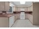 Bright kitchen with neutral cabinets, appliances, and white tile flooring at 5280 Oak Hill Ter, Cumming, GA 30040