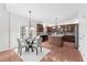 Bright kitchen with central island and hardwood floors connects to breakfast area at 5280 Oak Hill Ter, Cumming, GA 30040